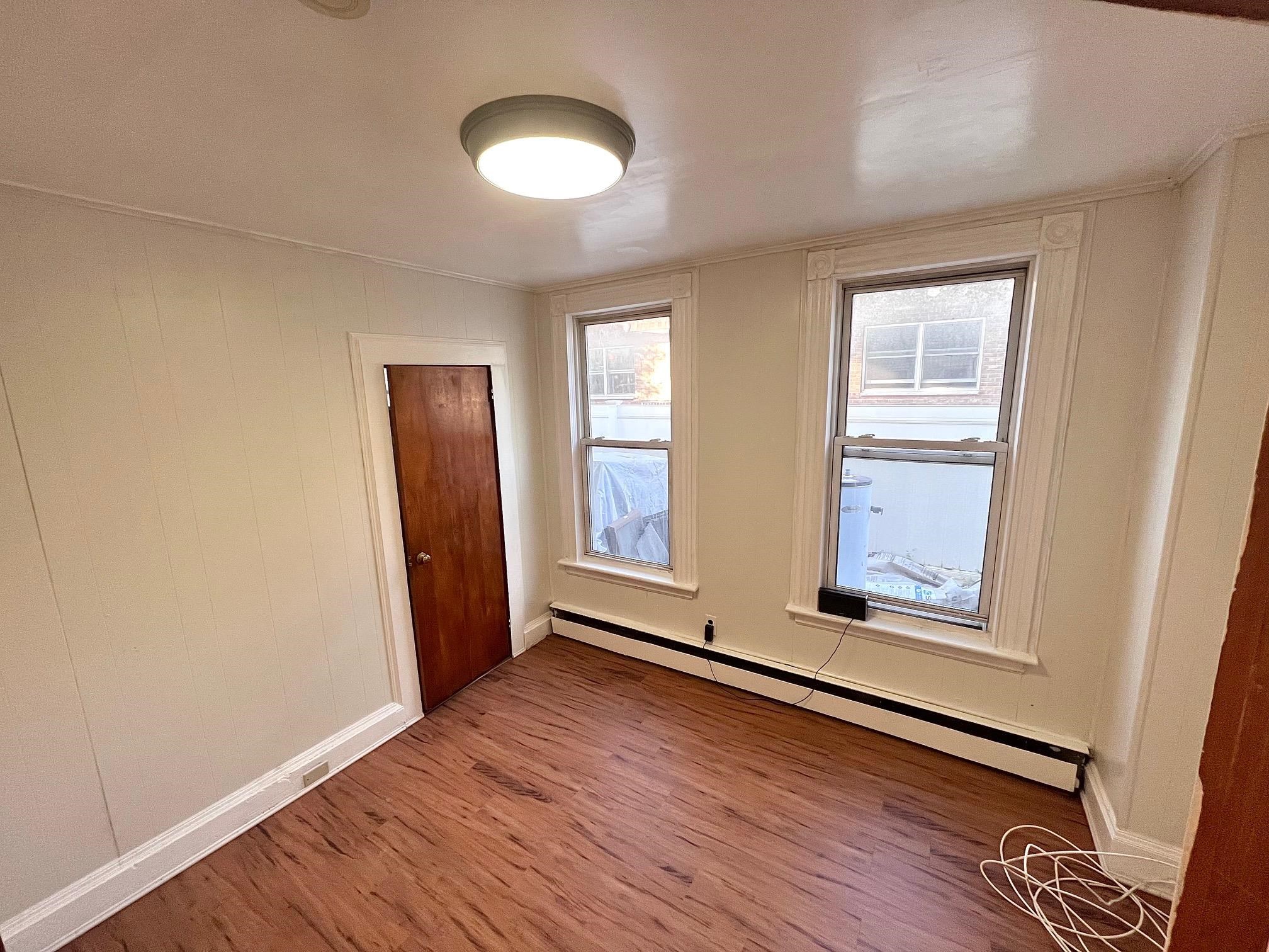 177 Park Avenue, Unit 2 East Rutherford, NJ 07073 - Photo 6 of 7 an empty room with wooden floor and windows