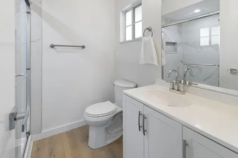 a bathroom with a sink toilet and shower