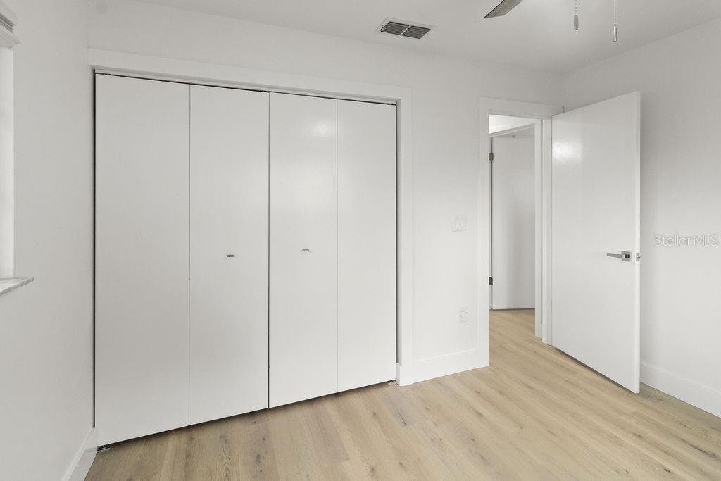 7579 Southwest 108th Place Ocala, FL 34476 - Photo 17 of 33 a view of an empty room with wooden floor