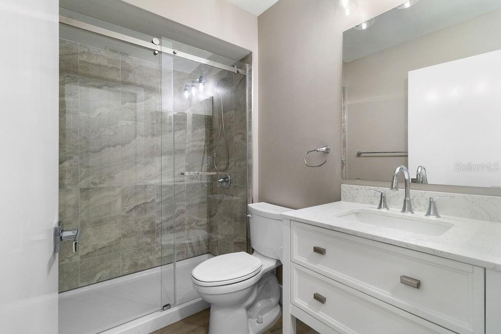 7579 Southwest 108th Place Ocala, FL 34476 - Photo 18 of 33 a bathroom with a sink a toilet and shower