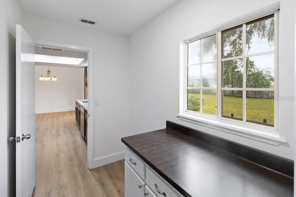 7579 Southwest 108th Place Ocala, FL 34476 - Photo 20 of 33 a view of a kitchen cabinets and a wooden floor