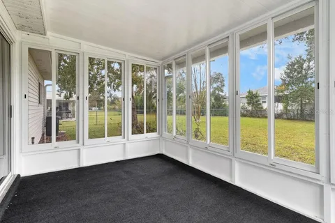 a view of an empty room with windows