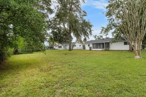 a view of a house with yard and tree s