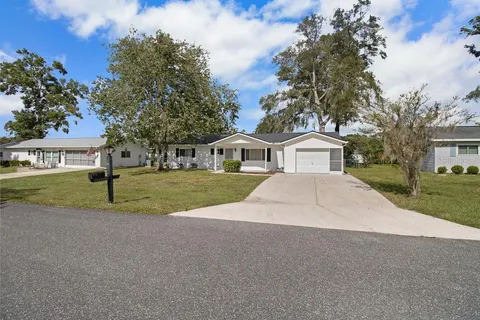 a view of house with outdoor space and parking