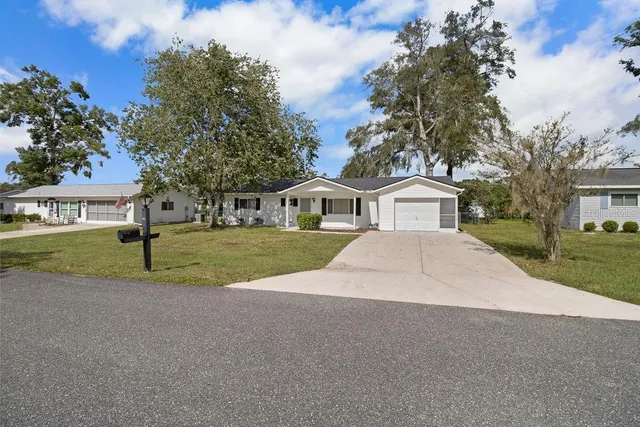 a view of house with outdoor space and parking