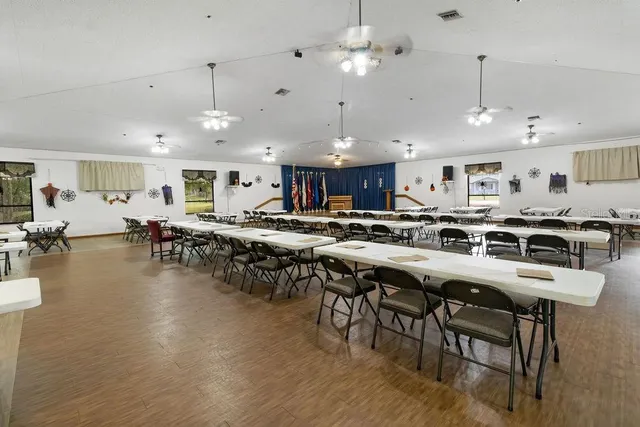 a kitchen with lots of wooden furniture appliances and a dining table