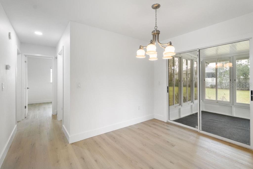 7579 Southwest 108th Place Ocala, FL 34476 - Photo 5 of 33 a view of a room with wooden floor fan and windows