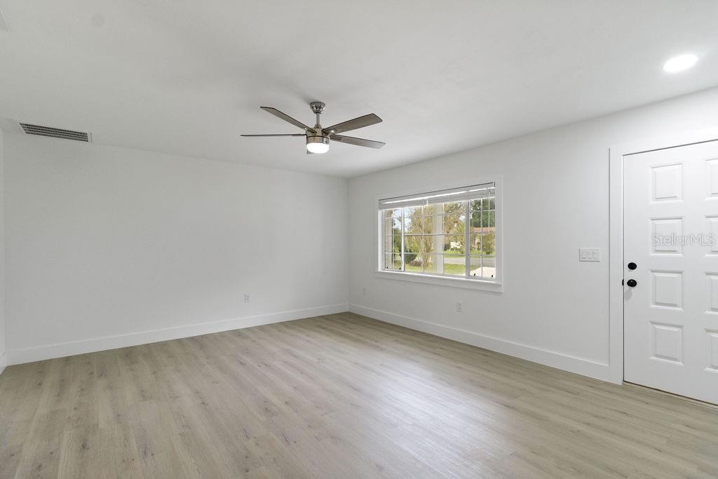 7579 Southwest 108th Place Ocala, FL 34476 - Photo 7 of 33 an empty room with wooden floor and windows