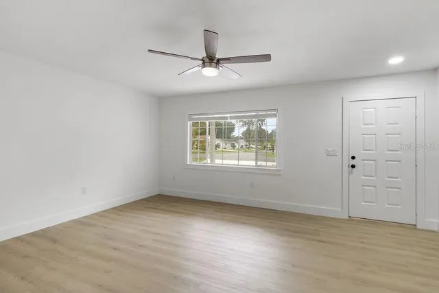 wooden floor in an empty room with a window