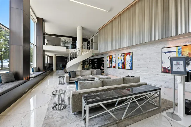 a living room with fireplace furniture and a large window