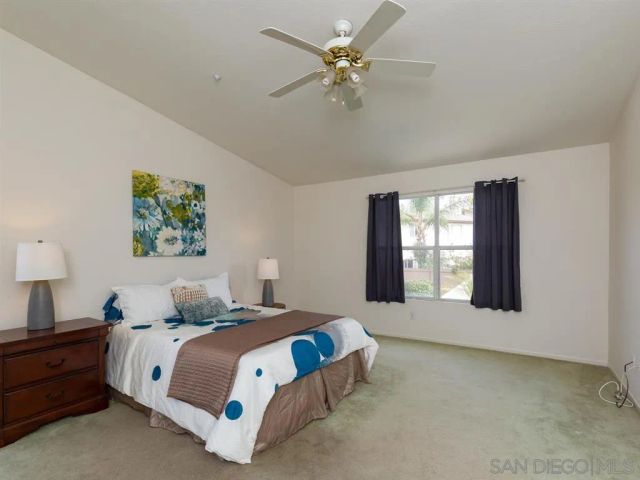 a spacious bedroom with a large bed and a window