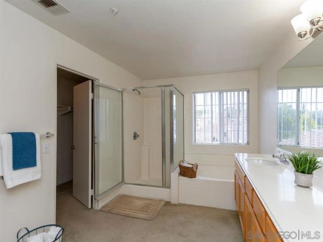 a spacious bathroom with a granite countertop tub sink and mirror