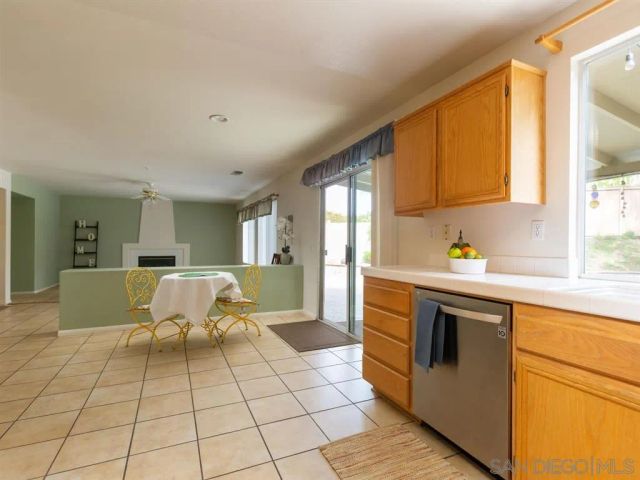 a living room with a sink and a stove top oven