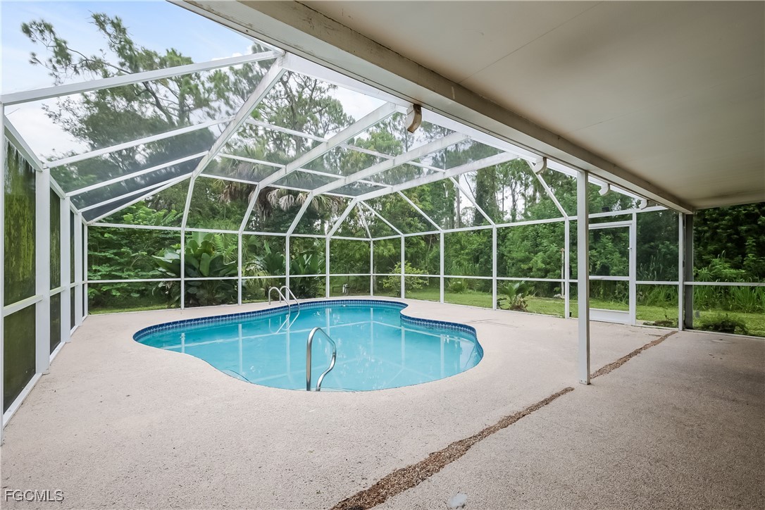 803 Hamilton Avenue Lehigh Acres, FL 33972 - Photo 15 of 16 a view of a house with a swimming pool