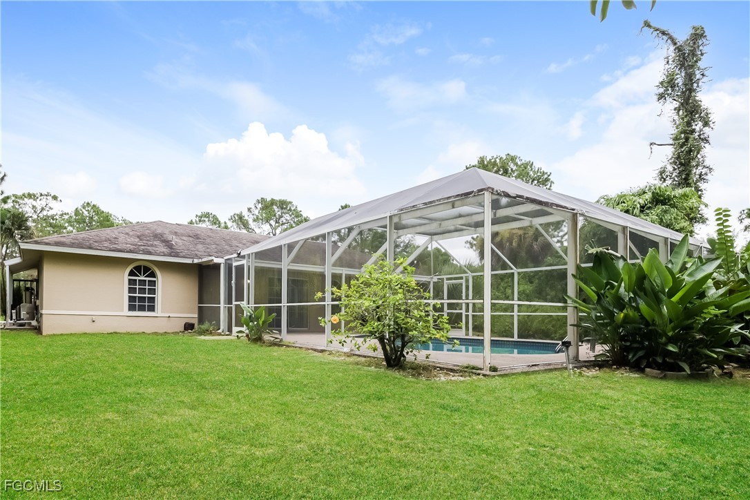 803 Hamilton Avenue Lehigh Acres, FL 33972 - Photo 16 of 16 a view of a house with a yard and plants