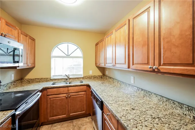 a kitchen with a sink a counter top space and cabinets