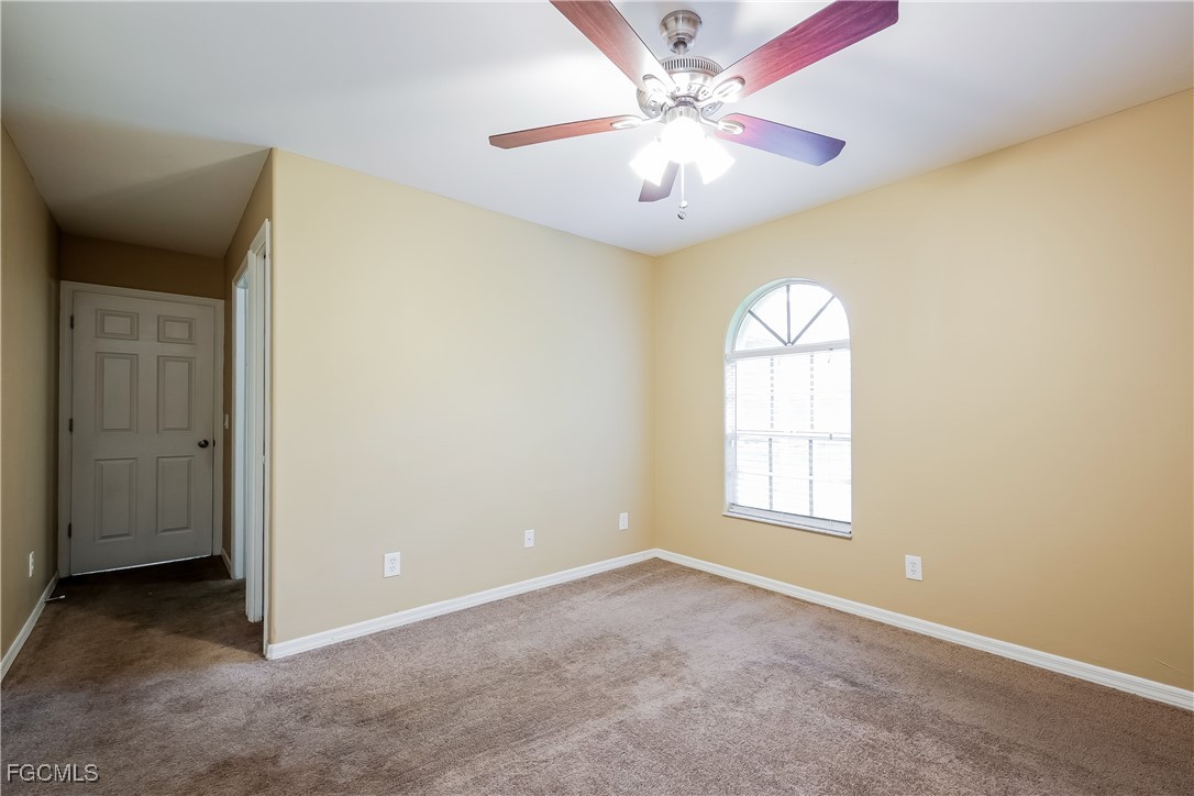 803 Hamilton Avenue Lehigh Acres, FL 33972 - Photo 9 of 16 an empty room with windows and fan