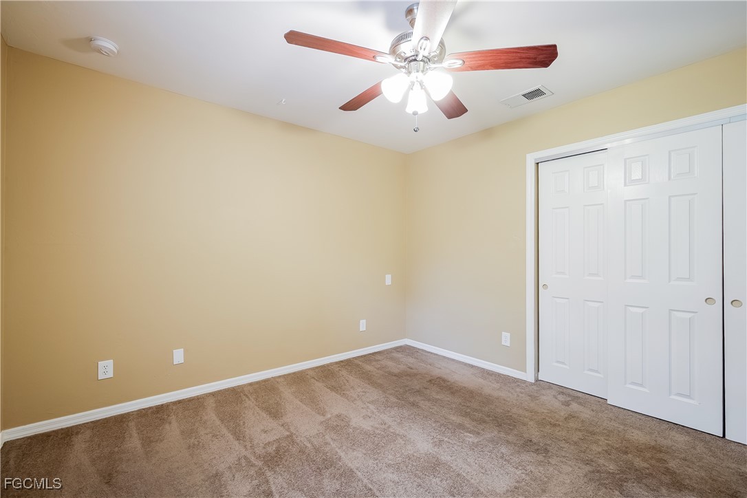 803 Hamilton Avenue Lehigh Acres, FL 33972 - Photo 10 of 16 wooden floor in an empty room