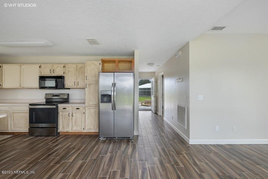 11101 Aaron Fish Road Glen St. Mary, FL 32040 - Photo 11 of 44 a kitchen with stainless steel appliances a refrigerator and wooden floor