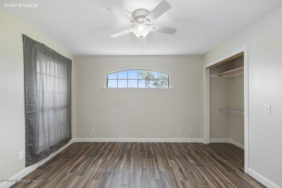 11101 Aaron Fish Road Glen St. Mary, FL 32040 - Photo 13 of 44 wooden floor in an empty room with a window