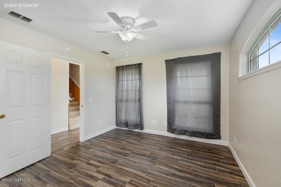 11101 Aaron Fish Road Glen St. Mary, FL 32040 - Photo 14 of 44 a view of an empty room with wooden floor