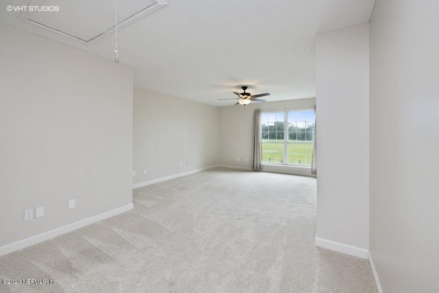 11101 Aaron Fish Road Glen St. Mary, FL 32040 - Photo 17 of 44 a view of an empty room with a chandelier fan