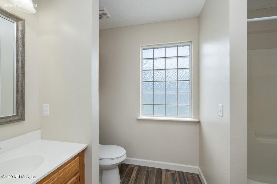 11101 Aaron Fish Road Glen St. Mary, FL 32040 - Photo 21 of 44 a bathroom with a sink a toilet and a window