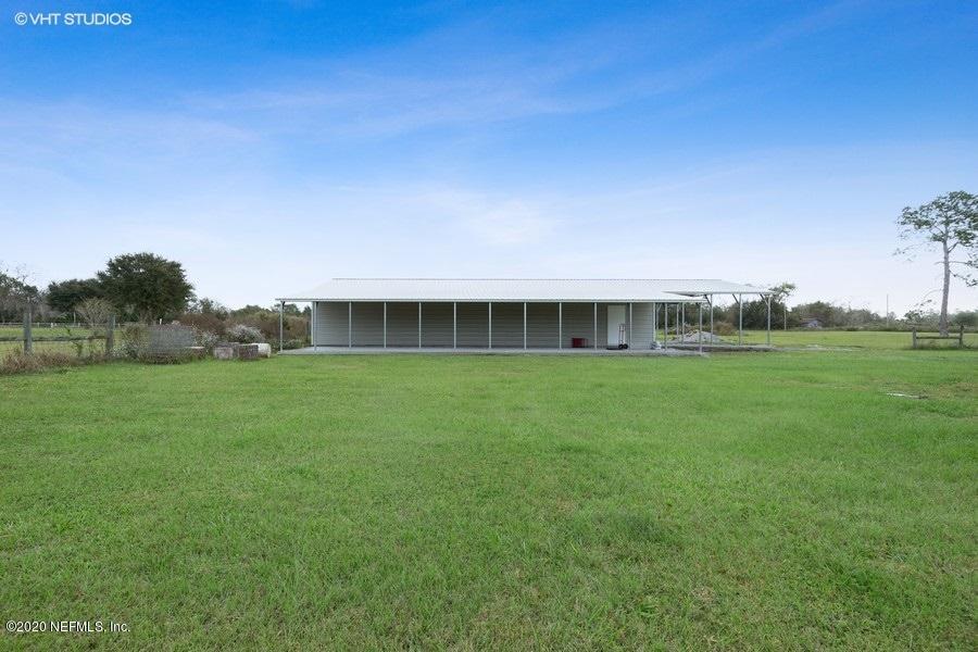 11101 Aaron Fish Road Glen St. Mary, FL 32040 - Photo 25 of 44 a front view of a house with a big yard