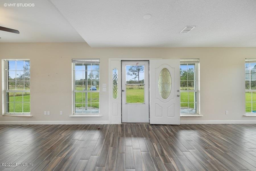 11101 Aaron Fish Road Glen St. Mary, FL 32040 - Photo 4 of 44 an empty room with wooden floor and windows