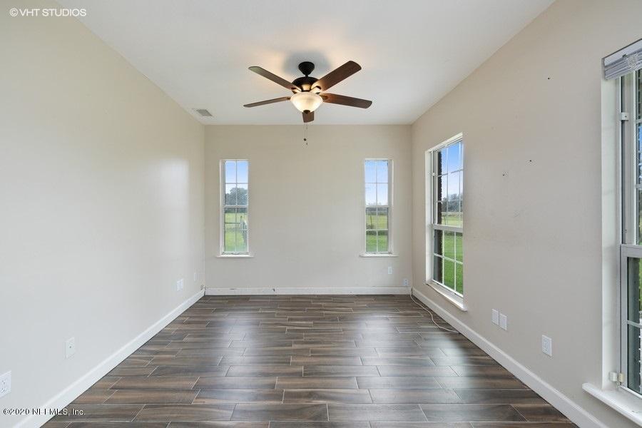 11101 Aaron Fish Road Glen St. Mary, FL 32040 - Photo 5 of 44 a view of empty room with wooden floor and fan