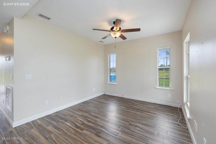 11101 Aaron Fish Road Glen St. Mary, FL 32040 - Photo 6 of 44 a view of empty room with wooden floor and fan