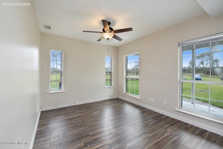 11101 Aaron Fish Road Glen St. Mary, FL 32040 - Photo 7 of 44 a view of an empty room with wooden floor and a window
