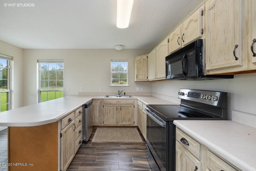 11101 Aaron Fish Road Glen St. Mary, FL 32040 - Photo 9 of 44 a kitchen with a sink stove and microwave