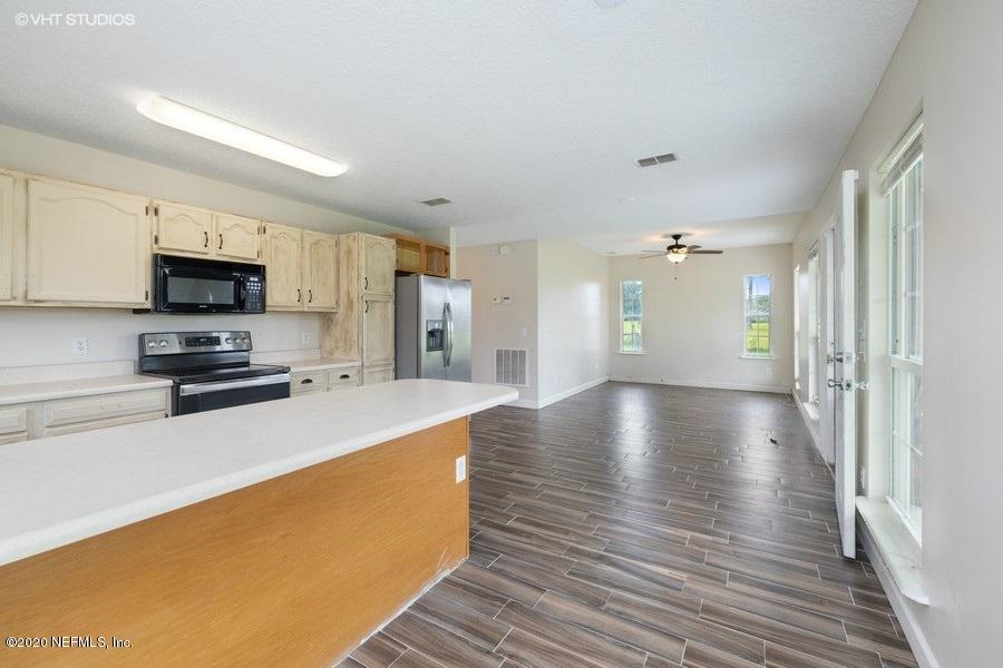 11101 Aaron Fish Road Glen St. Mary, FL 32040 - Photo 10 of 44 a view of kitchen with stainless steel appliances a refrigerator and a stove top oven