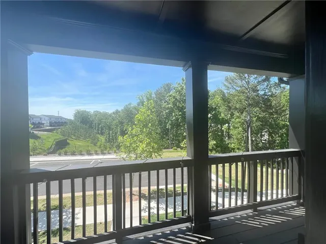 a view of a balcony with wooden floor