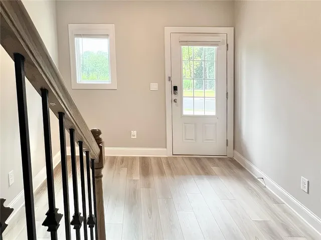 a view of an entryway with wooden floor and door
