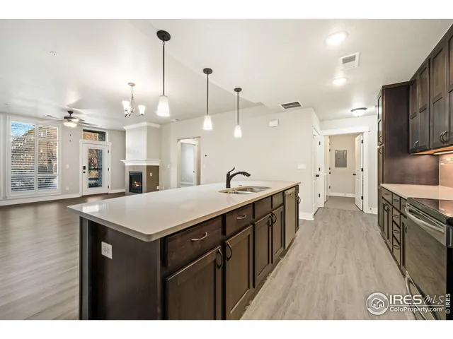 a kitchen with kitchen island a sink appliances and cabinets