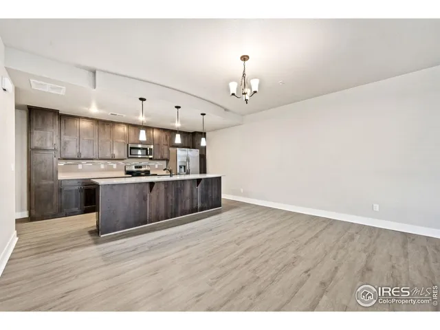 a kitchen with kitchen island a sink stainless steel appliances and cabinets