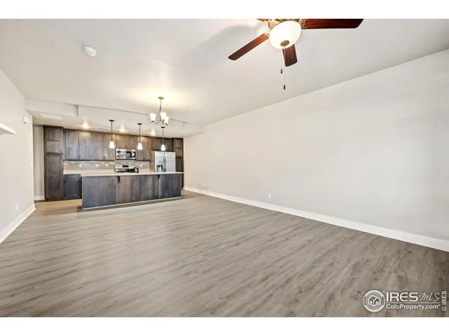 a kitchen with kitchen island white cabinets and granite counter tops
