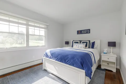 a bedroom with a large bed and a window
