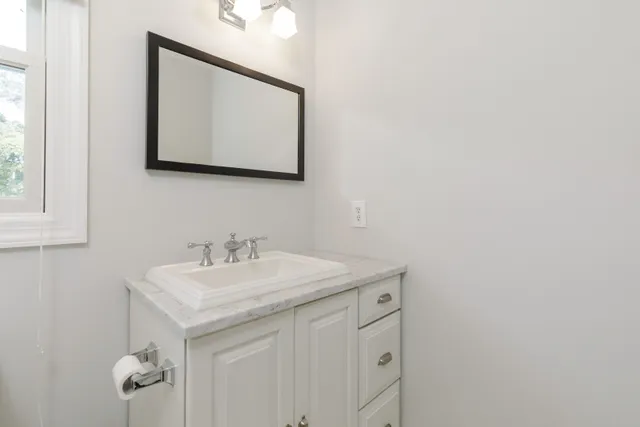 a bathroom with a sink and a mirror