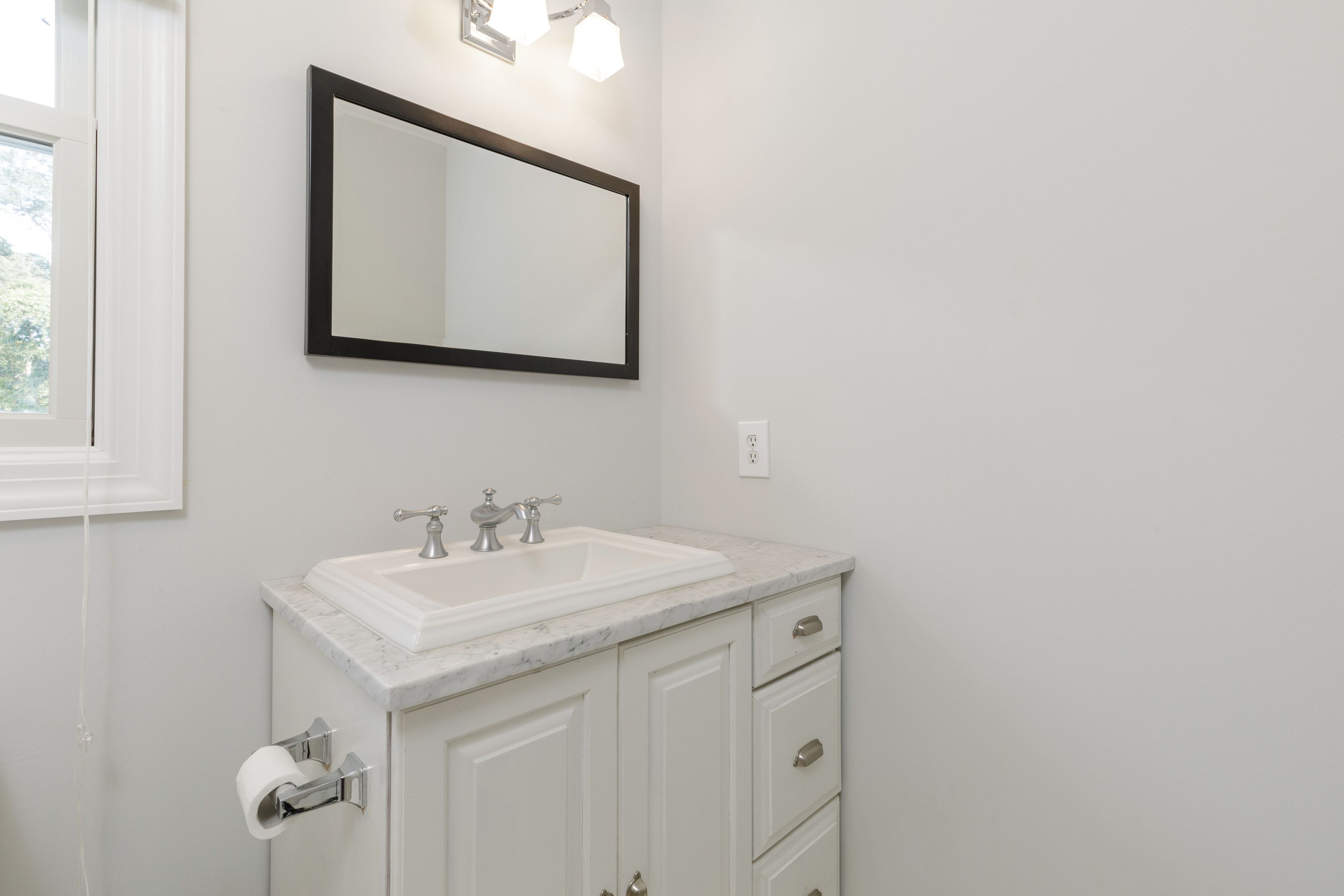 Undisclosed Address Southampton, NY 11968 - Photo 13 of 25 a bathroom with a sink and a mirror