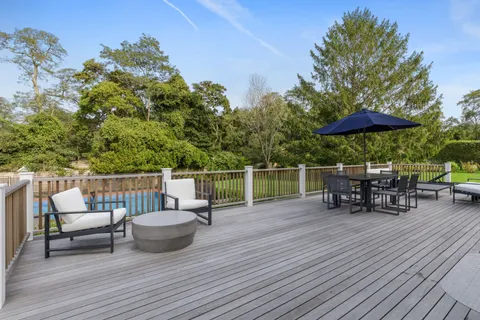 a view of chair and tables on the roof deck
