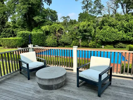 swimming pool view with a seating space