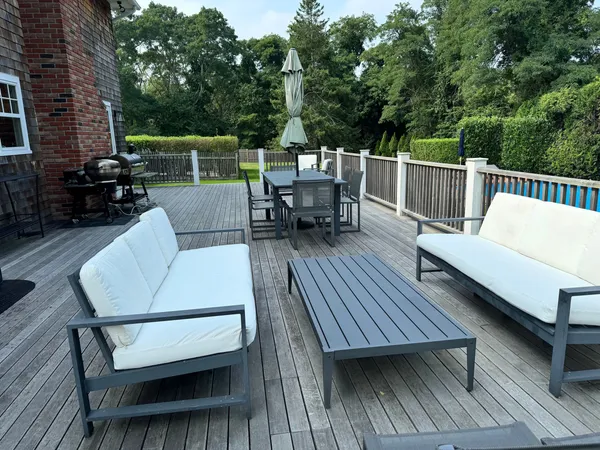 a view of a roof deck with dining and living space
