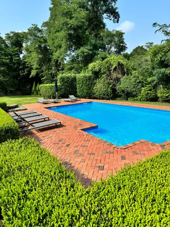 a view of a swimming pool with an outdoor space and seating area