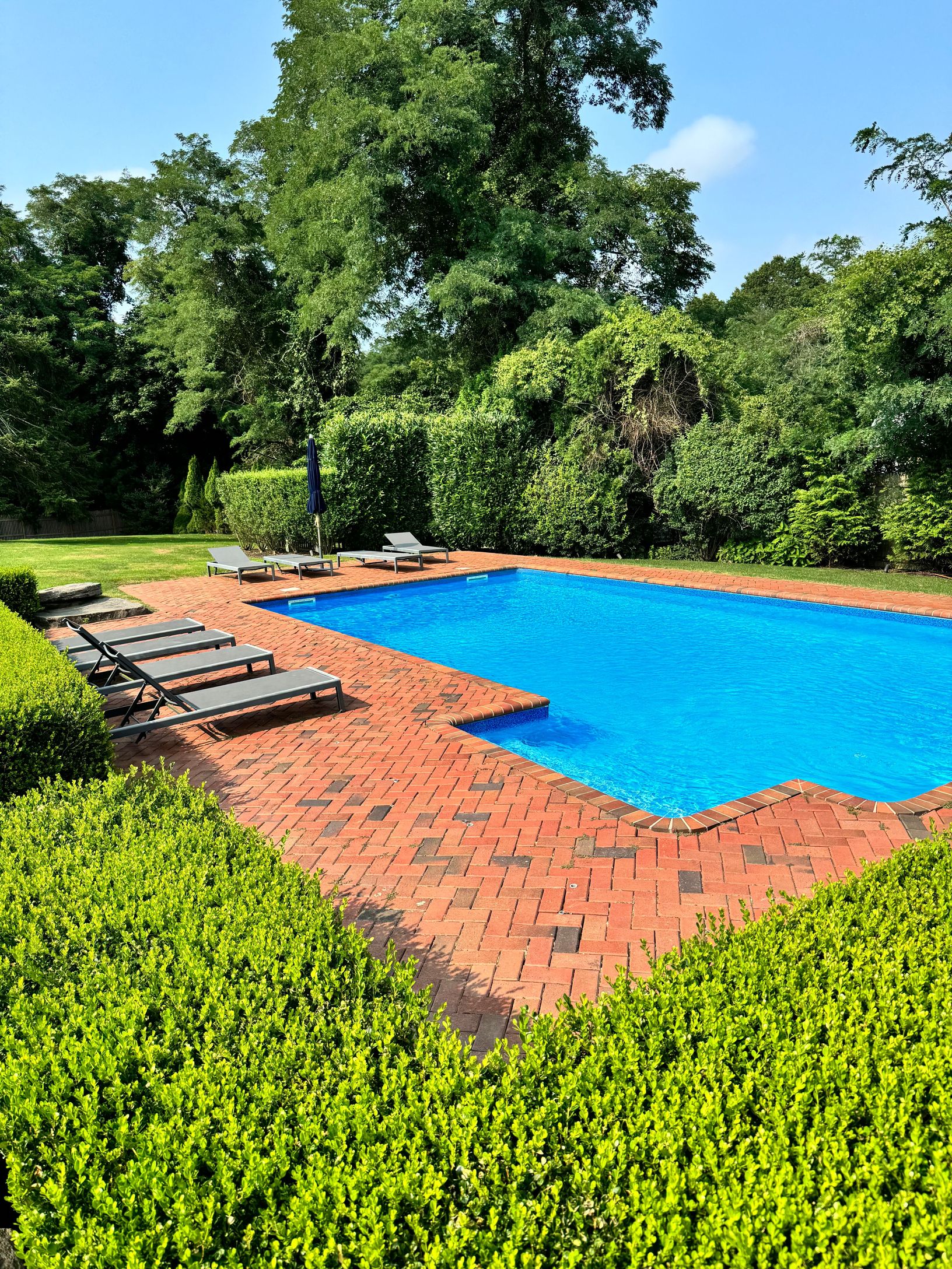Undisclosed Address Southampton, NY 11968 - Photo 2 of 25 a view of a swimming pool with an outdoor space and seating area