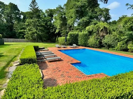 a view of a backyard with swimming pool