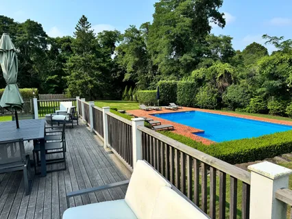a view of a chairs and table on the roof deck