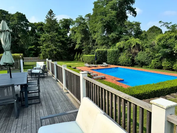 a view of a chairs and table on the roof deck